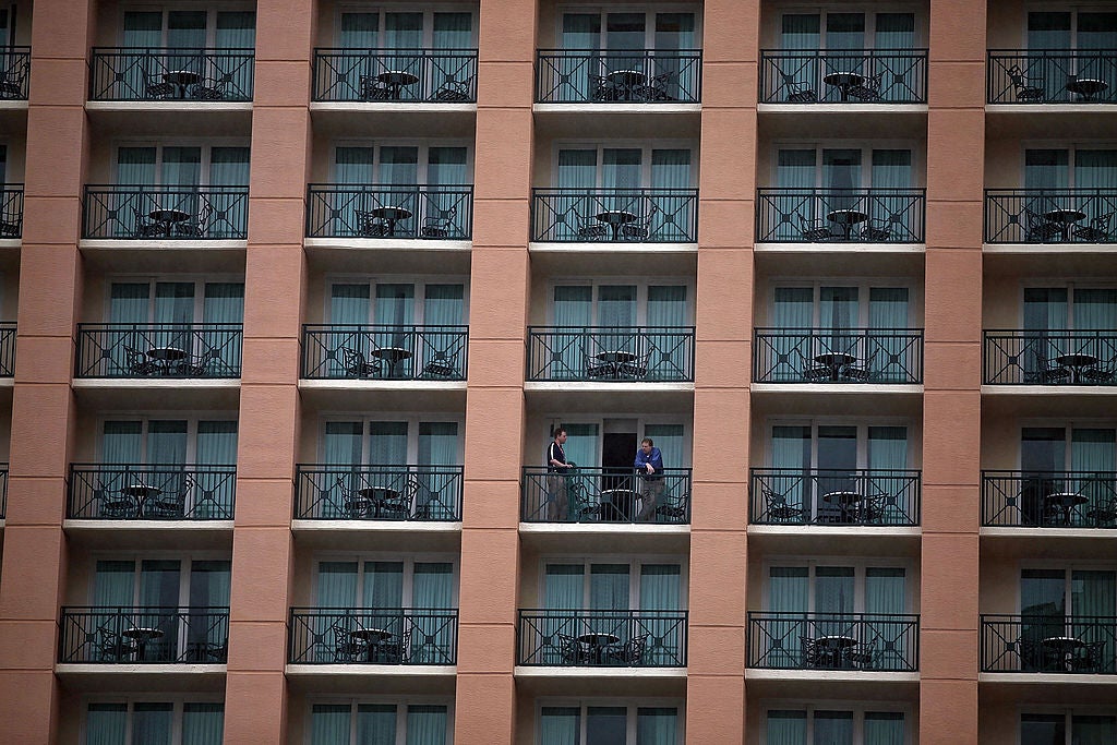 A Tampa, Florida hotel with people talking on the balcony. Florida Man Jumps Between Hotel Balconies To Evade Police