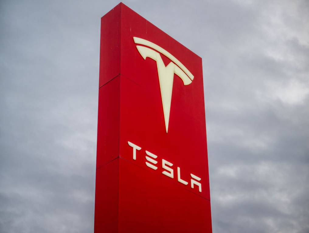 Large red Tesla Sign outside of a Tesla building