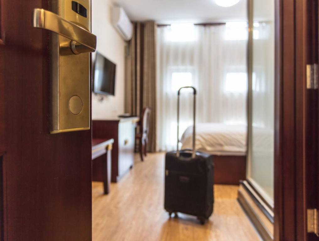 Suitcase delivered standing in hotel room. concept of Hotel service and travel