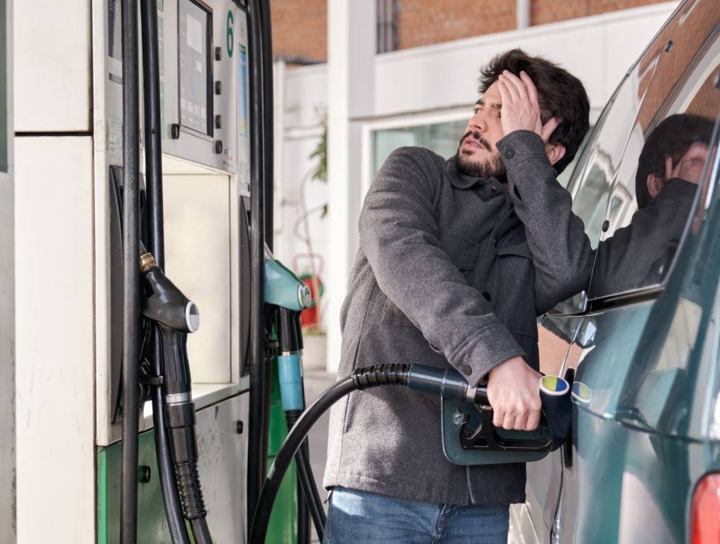 A man in disbelief after looking at gas prices while pumping gas into his car. Pumping gas in Las Vegas has turned into this feeling.