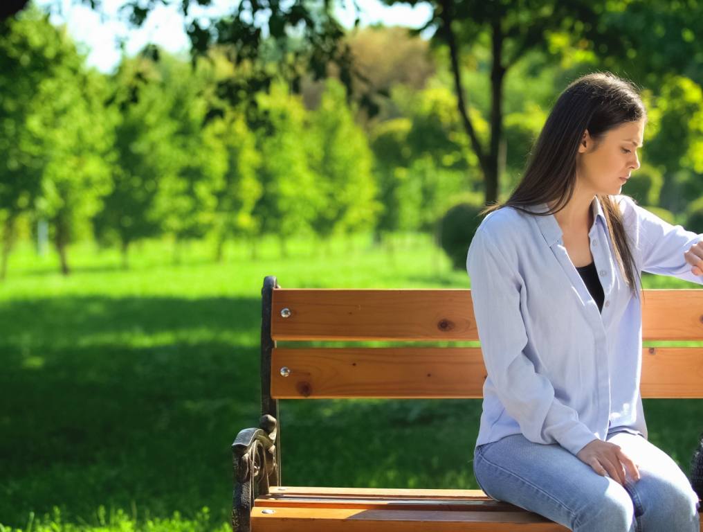 Woman looking at her watch waiting for her friend who's late!