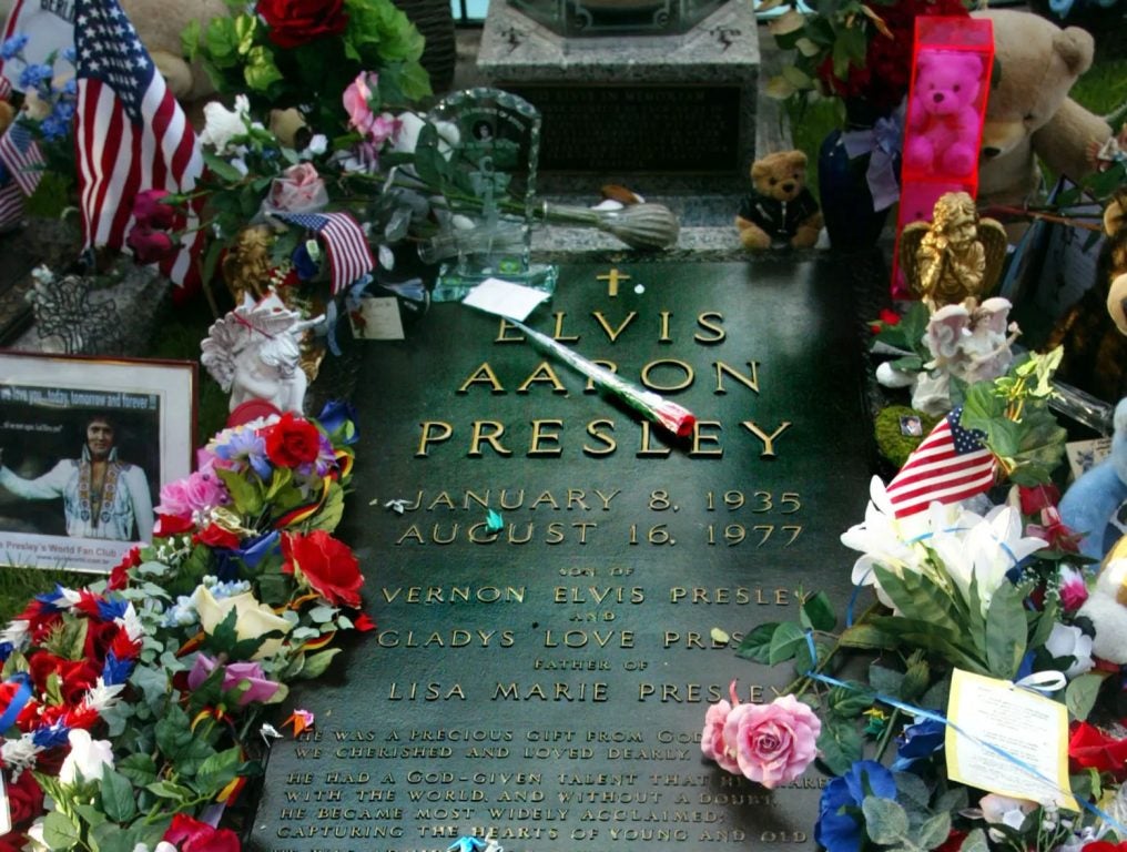 Flowers surround Elvis Presley's gravestone in the "Meditation Gardens" area of Graceland during Elvis Week on August 12, 2002 in Memphis, Tennessee. 75,000 fans are expected to attend the celebration of all things Elvis which this year marks the 25th anniversary of Presley's August 16, 1977 death. Graceland is the second-most visited home in America behind the White House.