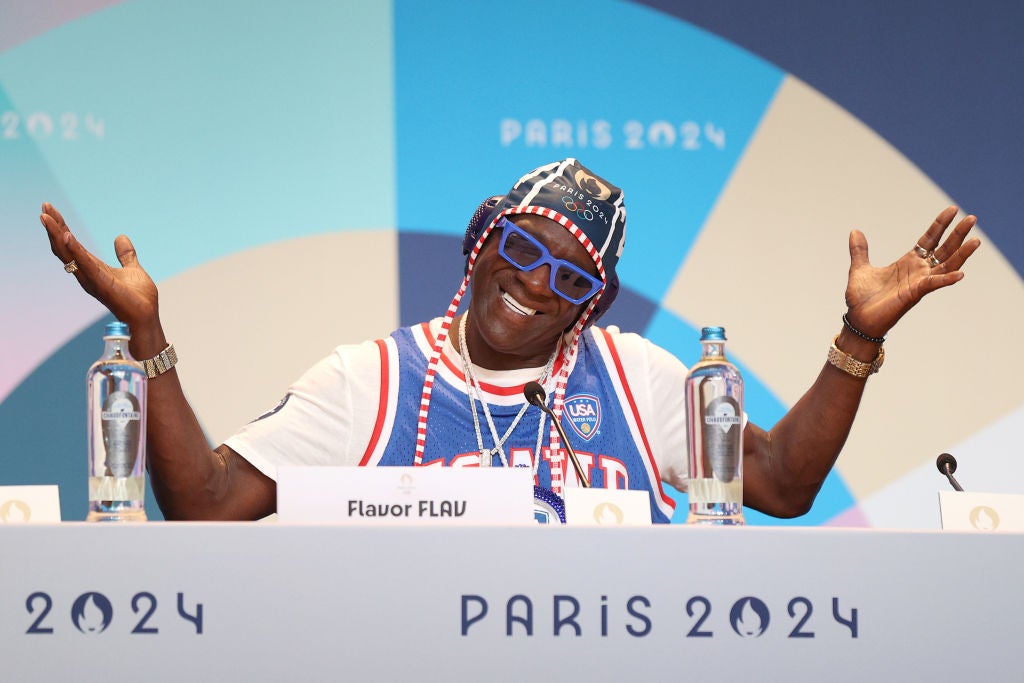 Flavor Flav smiling, wearing his water polo swim cap