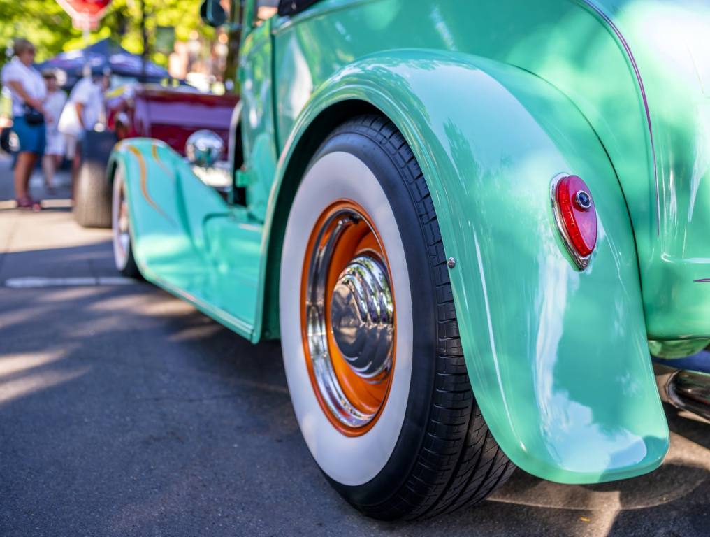 Close up of the bumper of a vintage turquoise classic car on display in a car show. Concept: Henderson Hot Rod Days free car show