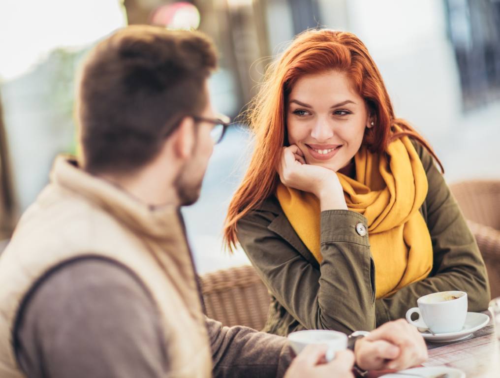 Attractive young couple in love sitting at the cafe table. North Las Vegas men ranked high in new dating survey.