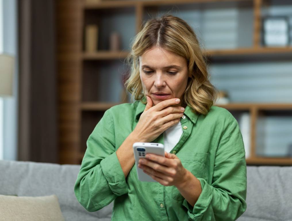 A woman on the phone making sure it's not a scam.