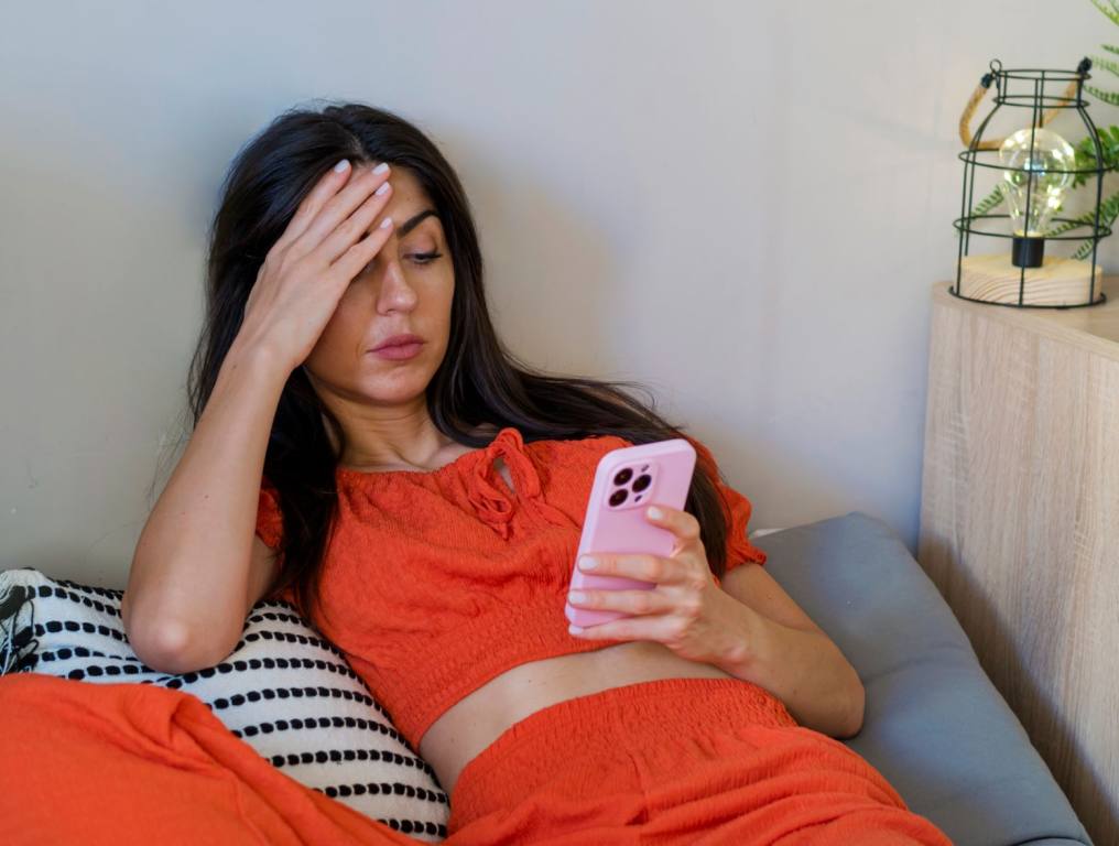 Woman on her phone doing online dating. Nevada is actually the most dangerous state for online dating, and here's why.