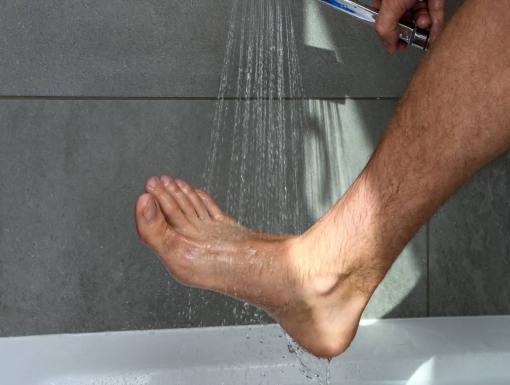 In the shower washing your feet.