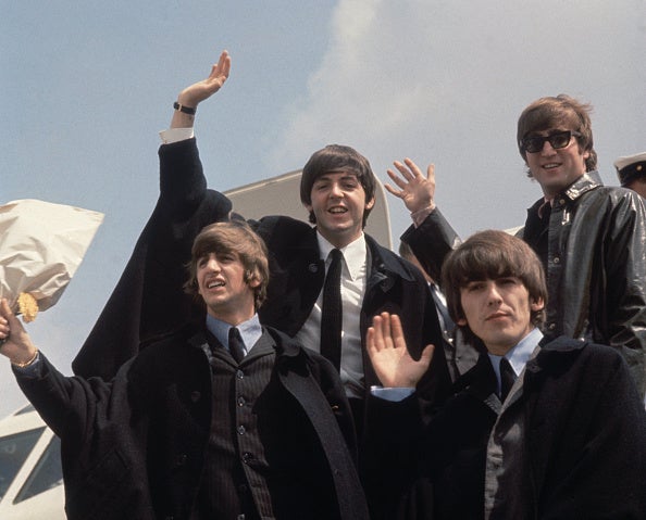 The Beatles (from left to right, John Lennon (1940 - 1980), George Harrison (1943 - 2001), Paul McCartney and Ringo Starr) arrive back at London Airport after their Australian tour.