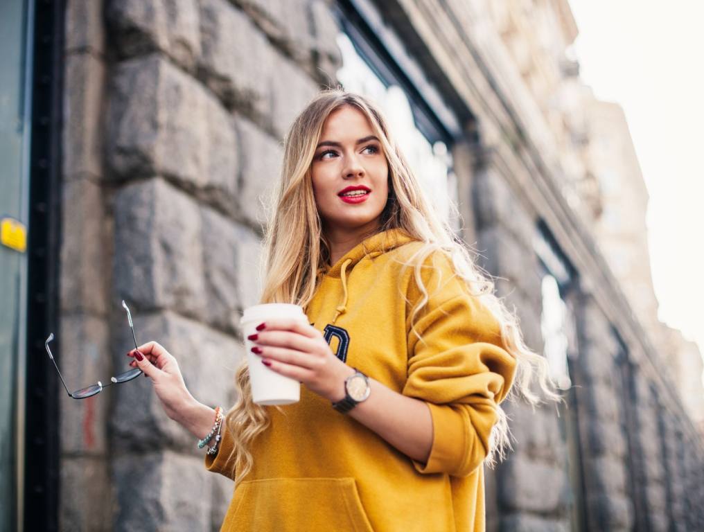 Woman in hoodie with coffee. You won't be short of things to do during the months of September, October and November, either. Here's your fall checklist and things to love about the season.