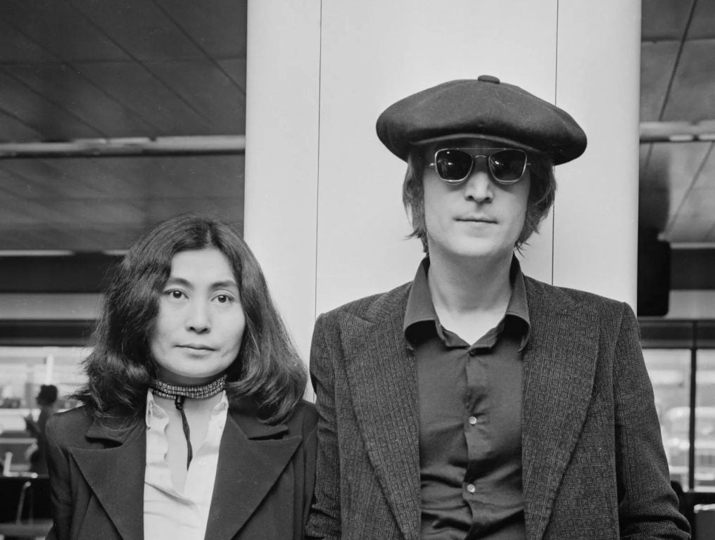 John Lennon (1940 - 1980) and his wife Yoko Ono arrive at London Airport from New York, 14th July 1971.