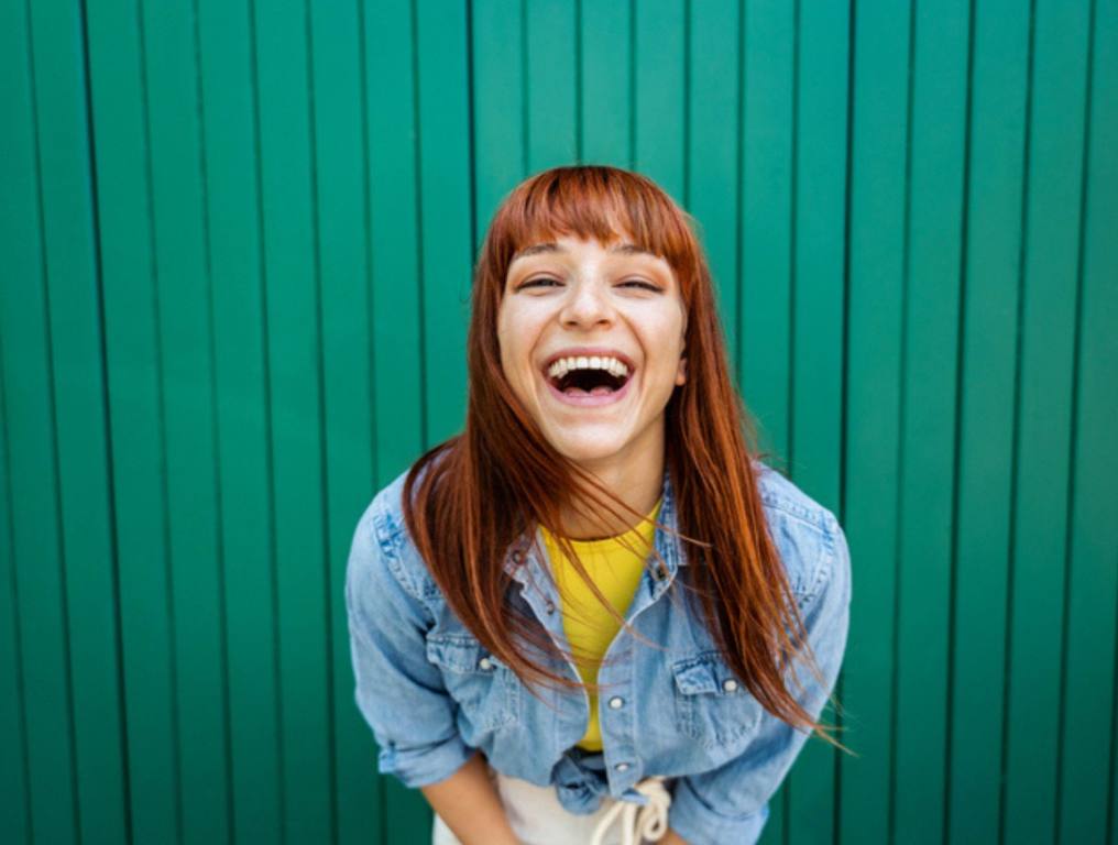 Young beautiful caucasian red hair woman laughing at the camera