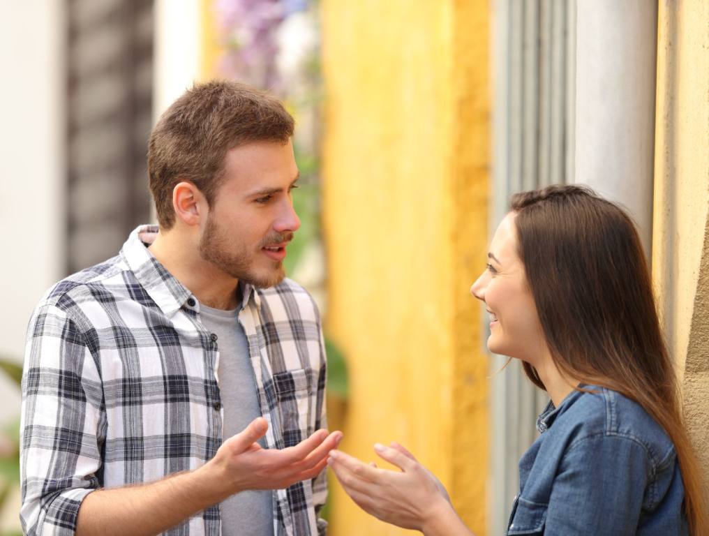 Couple talking standing in a colorful street