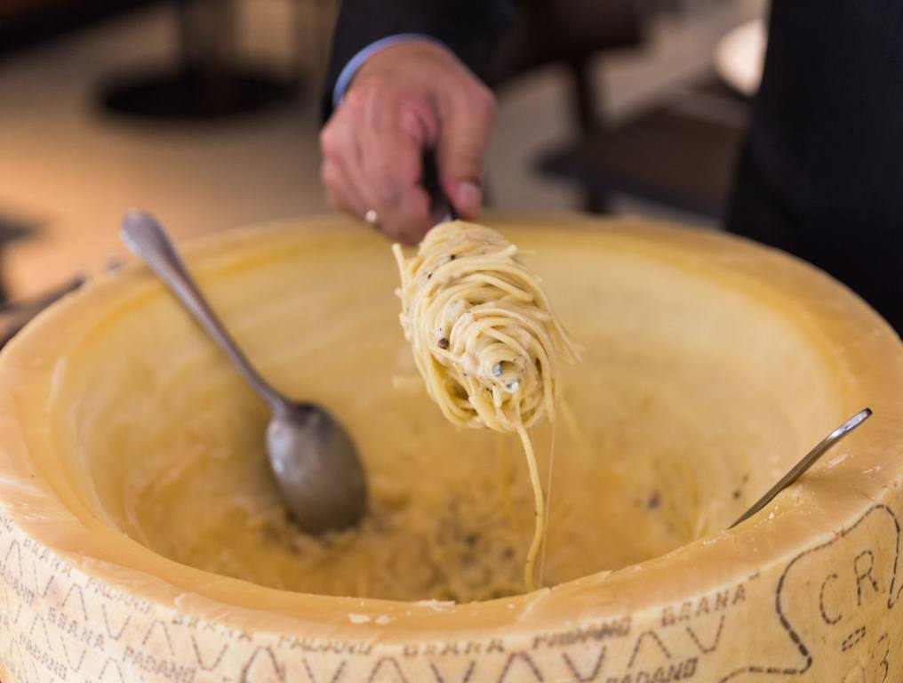 A pasta in a big cheese wheel. This is one out of the many types of pasta in Las Vegas that is delicious and filling.