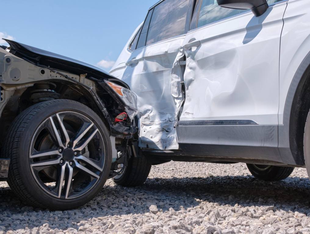 Close up of two cars in a collision. A black car has crashed into the driver's side of a white car. Concept of driving on Labor Day weekend in Vegas.