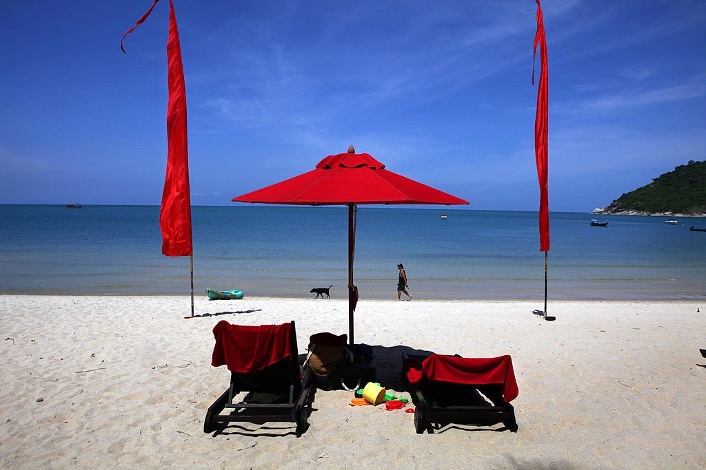 Chairs and an umbrella out on a beach in Thailand. Here's What A $1-Per-Night Airbnb Looks Like In Thailand