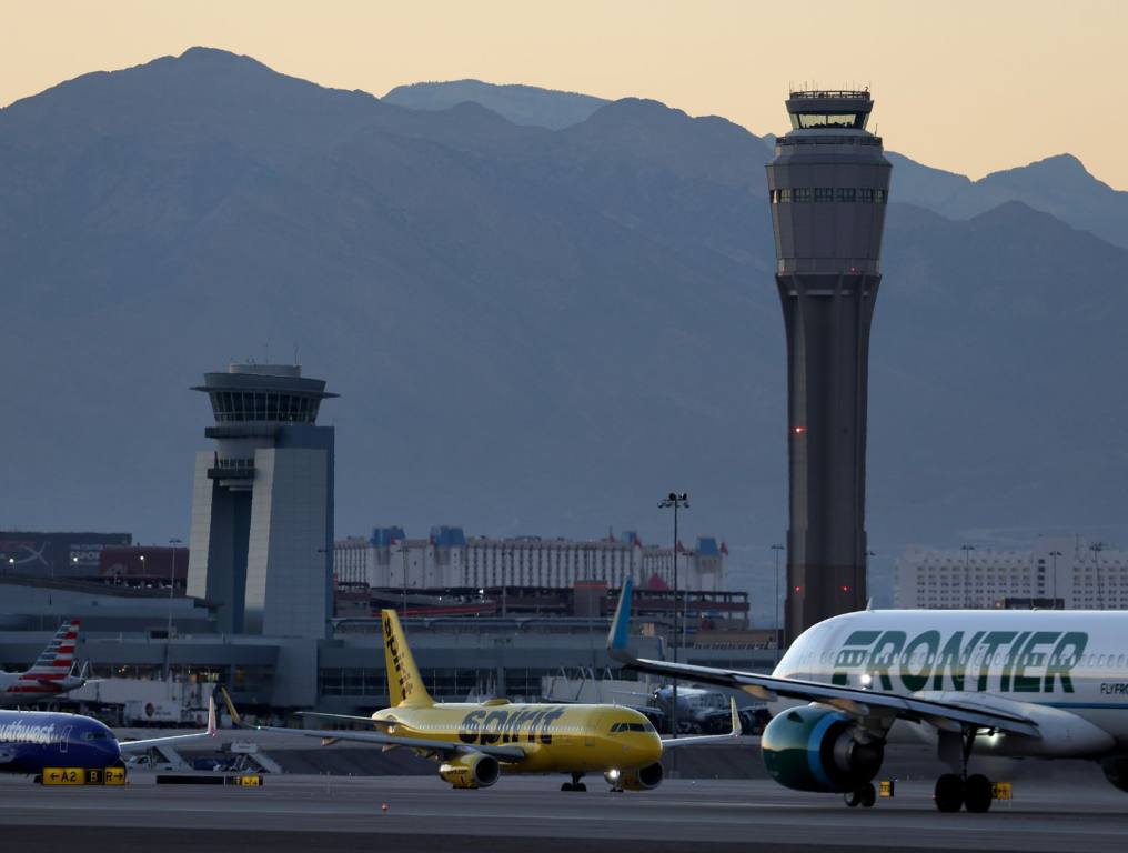 A photo of the Harry Reid International Airport runway with Spirit and Frontier aircrafts