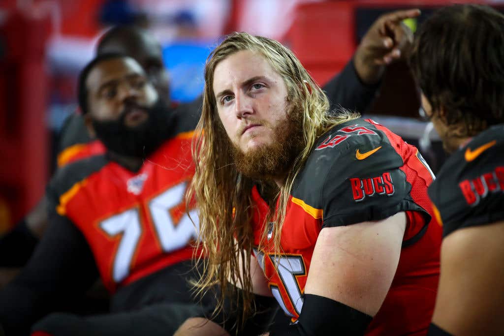 TAMPA, FL - AUGUST 23: Alex Cappa #65 of the Tampa Bay Buccaneers looks on from the bench during the fourth quarter of the preseason game against the Cleveland Browns at Raymond James Stadium on August 23, 2019 in Tampa, Florida.