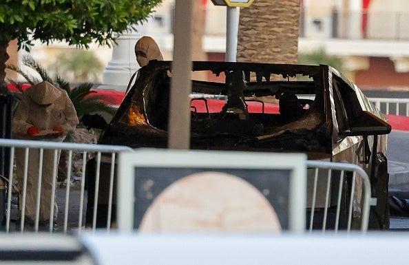 First responders wearing Hazmat gear investigate a Tesla Cybertruck that exploded in front of the entrance to the Trump International Hotel & Tower Las Vegas on January 01, 2025 in Las Vegas, Nevada. A person who was in the vehicle died and seven people were injured. Authorities are investigating the incident as a possible terrorist attack and are looking for a possible connection to a deadly crash in New Orleans. (Photo by Ethan Miller/Getty Images)