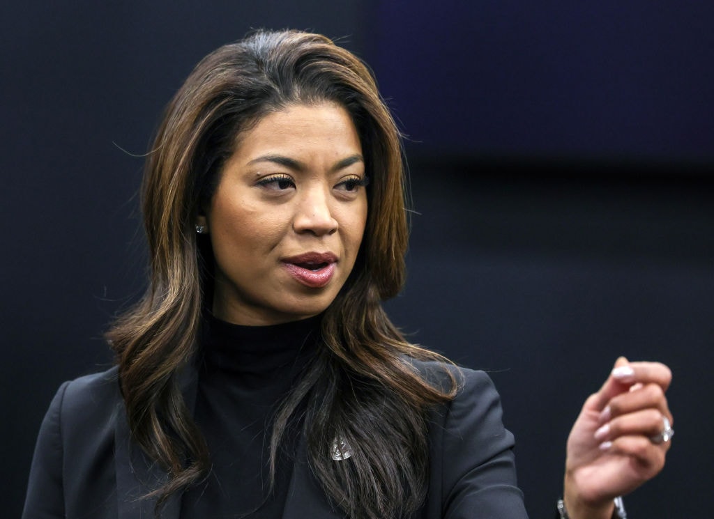 las vegas raiders president sandra douglass morgan gesturing with her hand on dark background