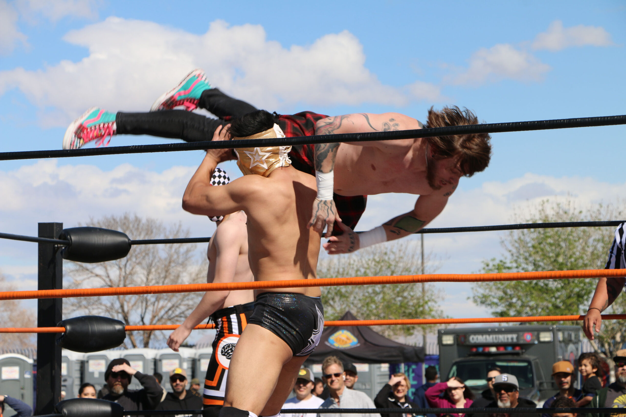 Two luchadores wrestle at Tacos and Tamales Fest.